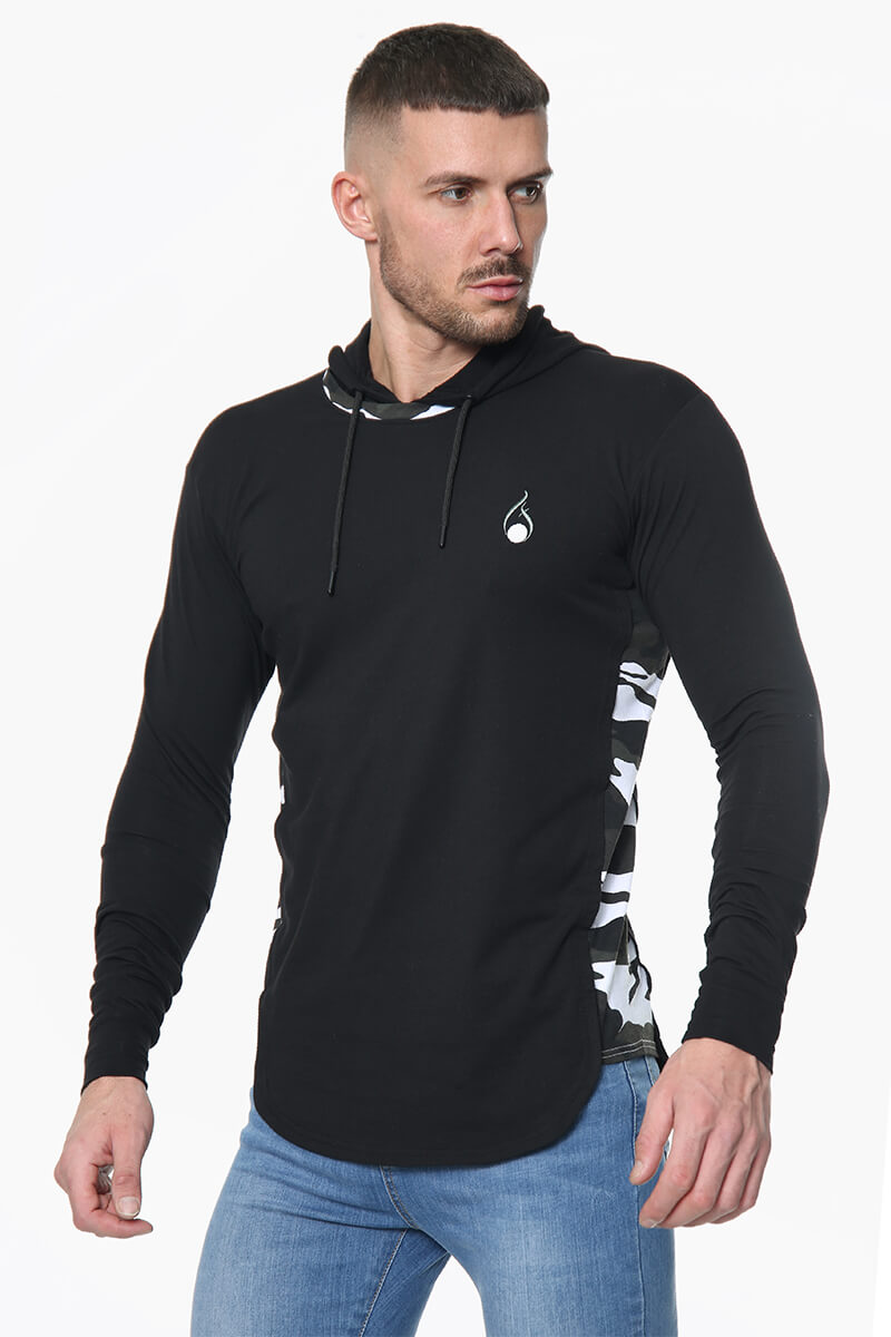 A man wearing a black Prestige Camo Hooded Tee featuring camo-print side panels and hood lining.