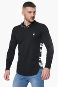 A man wearing a black Prestige Camo Hooded Tee featuring camo-print side panels and hood lining.