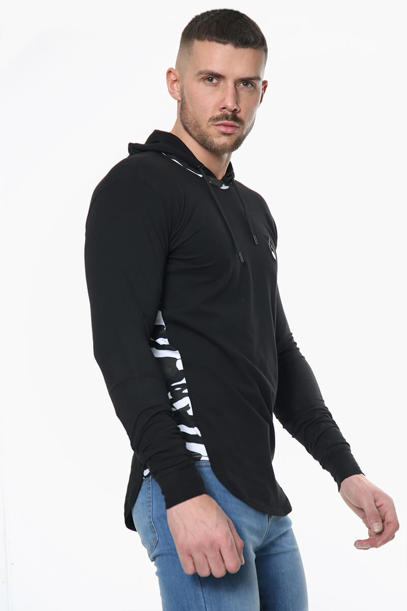A man wearing a black Prestige Camo Hooded Tee featuring a white camouflage stripe down the sleeves.